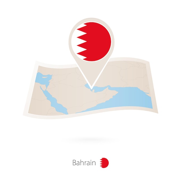 Folded paper map of Bahrain with flag pin of Bahrain