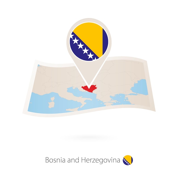 Folded paper map of Bosnia and Herzegovina with flag pin of Bosnia and Herzegovina