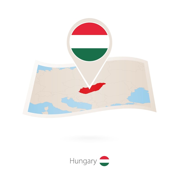 Folded paper map of Hungary with flag pin of Hungary