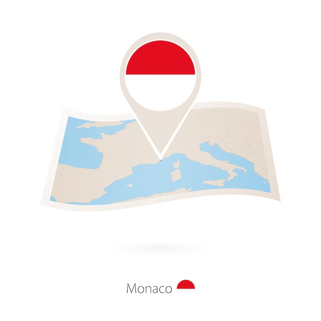 Folded paper map of Monaco with flag pin of Monaco