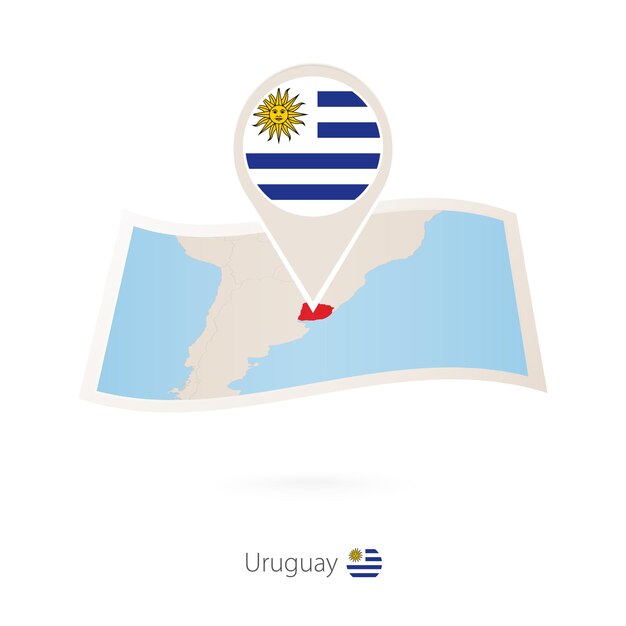 Folded paper map of Uruguay with flag pin of Uruguay