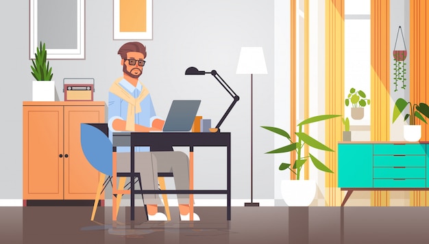 freelancer using laptop man sitting at workplace self-isolation coronavirus pandemic quarantine