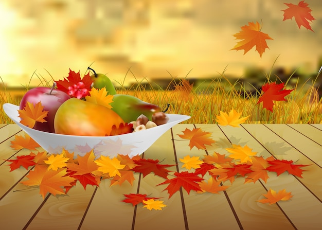 fruits and autumn leaves on a plate on wooden table