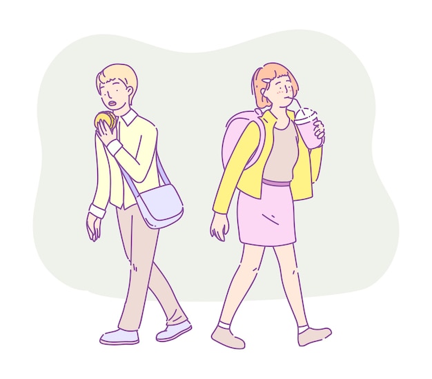 Girl and boy students eating fast food meal while walking