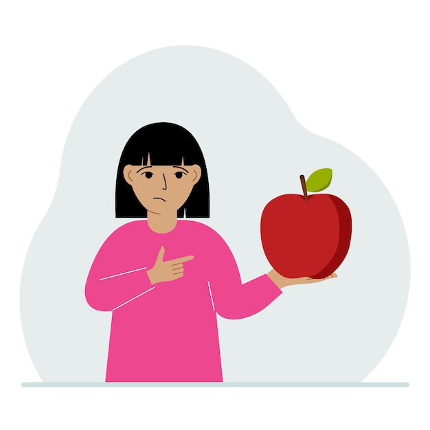 A girl holds a fresh and red apple in his hand Girl eats an apple Healthy food concept