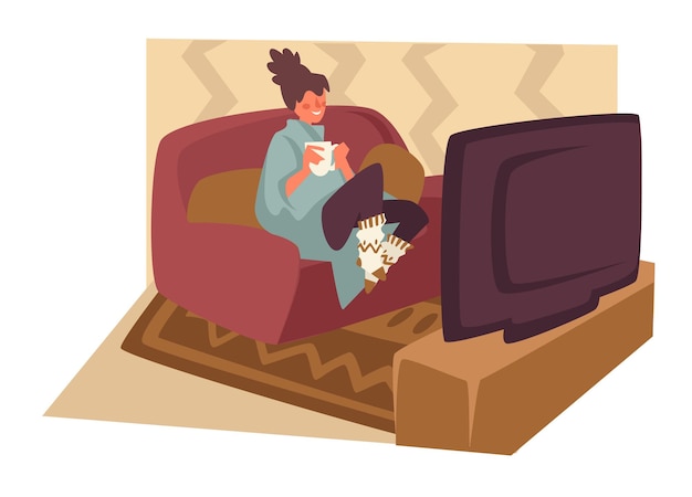 Girl watching tv and lying on sofa with tea and cocoa