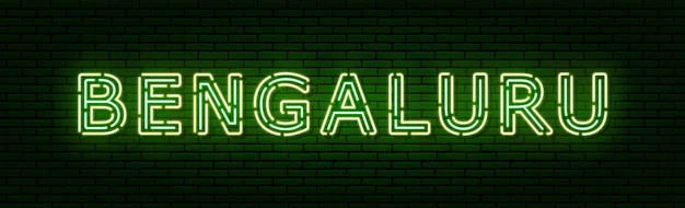 Glowing neon sign with the inscription of the Indian city of Bengaluru. In green and yellow colors. Against a brick wall. All elements are isolated.