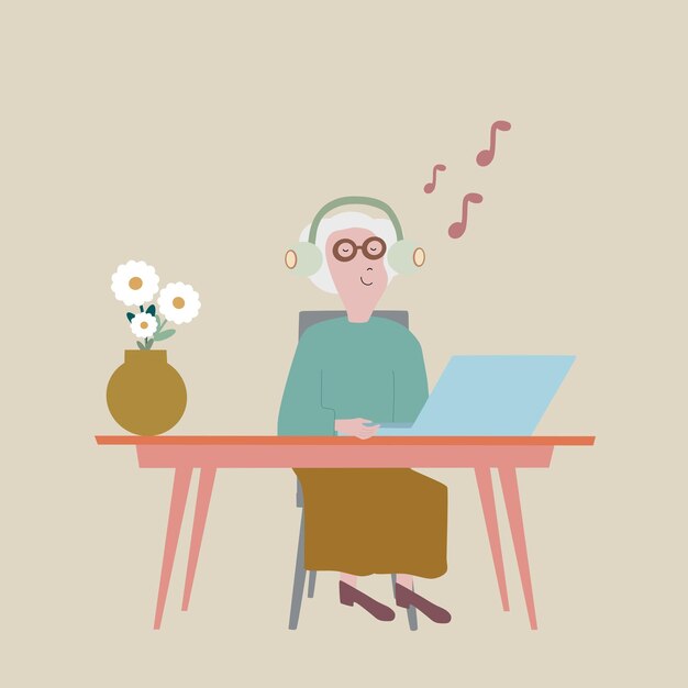 Grandma is sitting at her laptop and listening to music with headphones.There is a vase of flowers