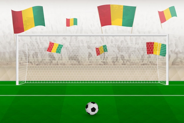 Guinea football team fans with flags of Guinea cheering on stadium penalty kick concept in a soccer match