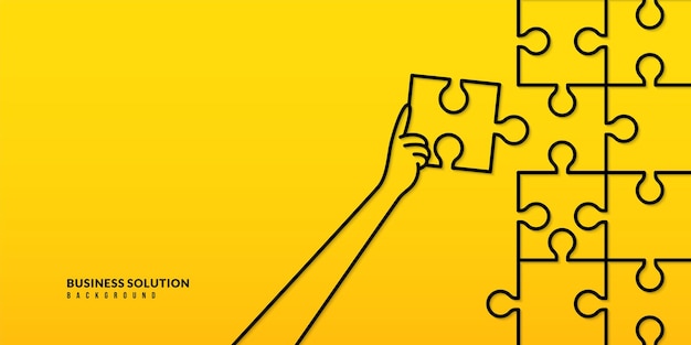 Hand holding jigsaw to completion last puzzle piece on yellow background Busniess solution concept