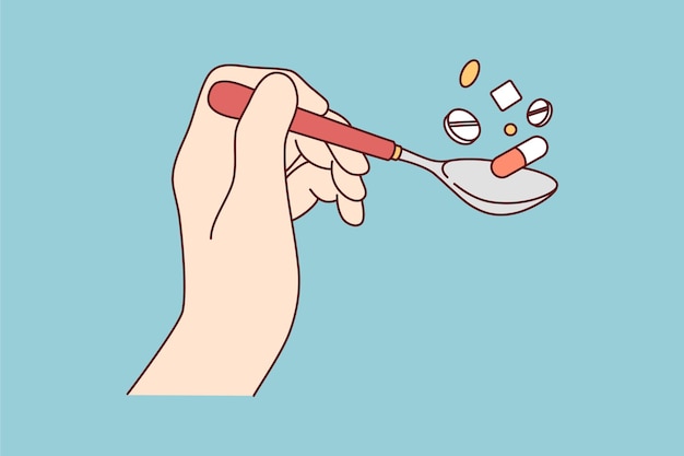 Hand holding spoon of pills