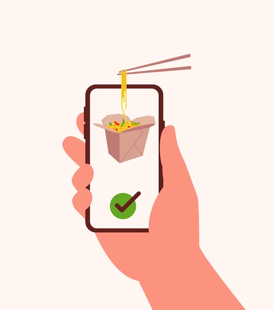 Hand holds smartphone with asian noodle with vegetables in paper box and chopsticks with noodles