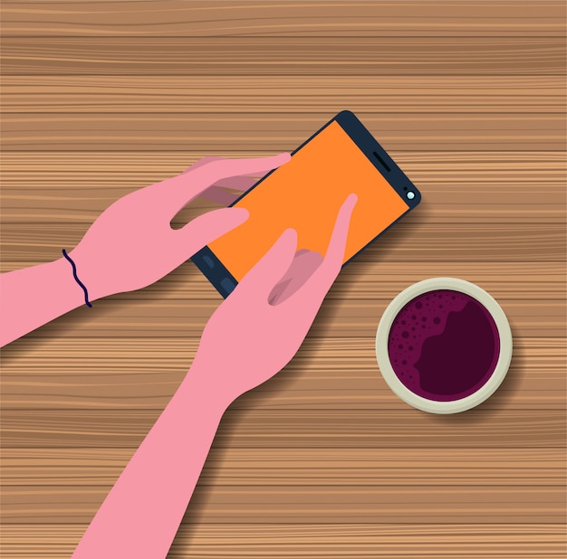 hand using smartphone with coffee cup in the table