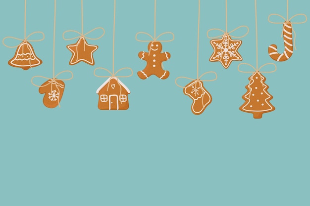 Hanging gingerbread cookies on blue background Christmas template for banner greeting card