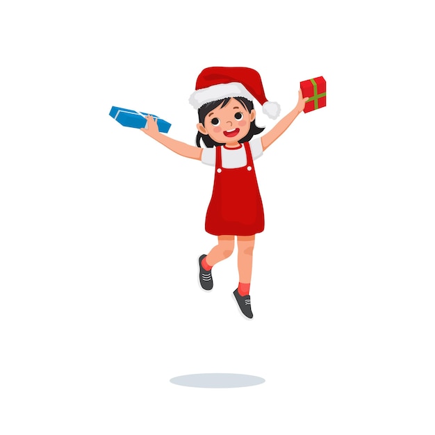 Happy cute young girl in Santa hat jumping and holding Christmas present