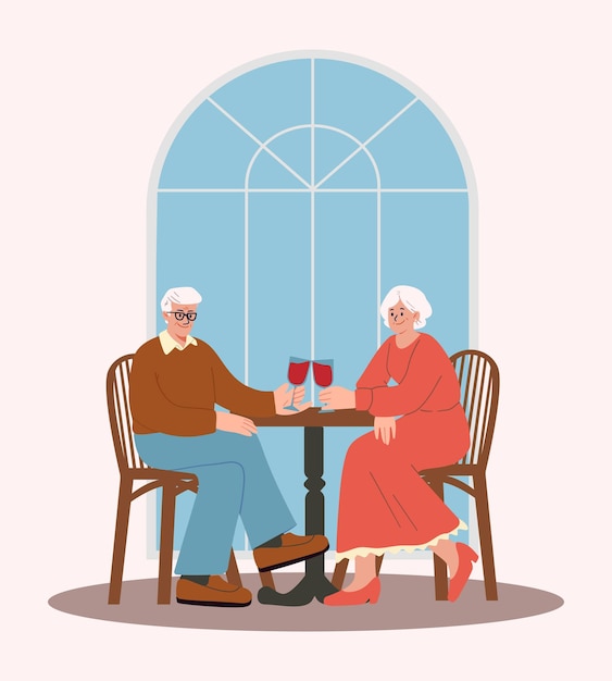 Happy elderly couple on a date in a restaurant having dinner and drinking red wine