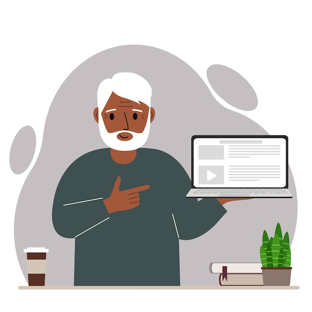 Happy grandfather holding a laptop computer with one hand and pointing at it with the other. Laptop computer technology concept.