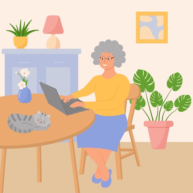 Happy grandmother with a laptop is sitting in the living room