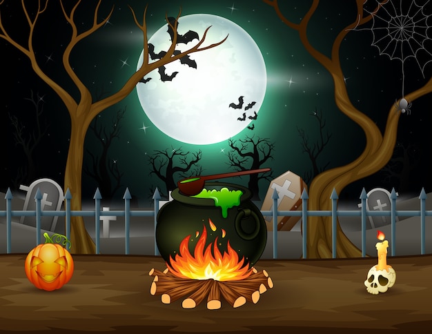 Happy Halloween with a potion in a cauldron in front a graveyard