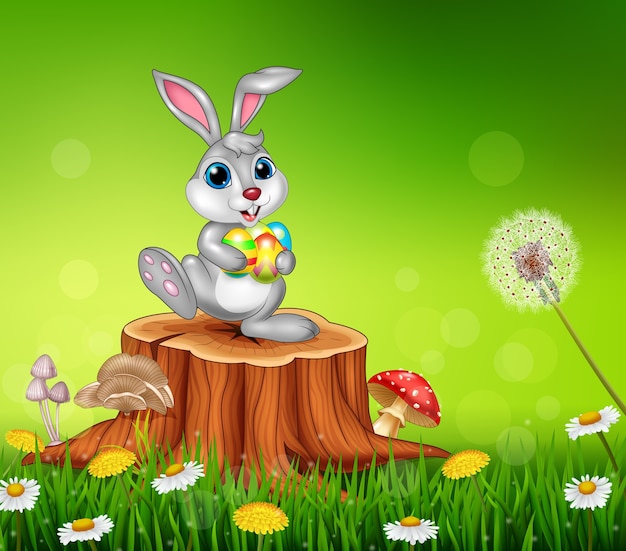 Happy little bunny holding easter eggs