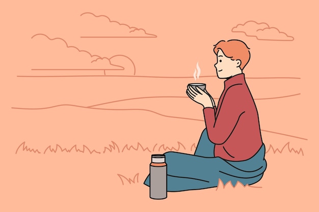 Happy man drinking tea in nature