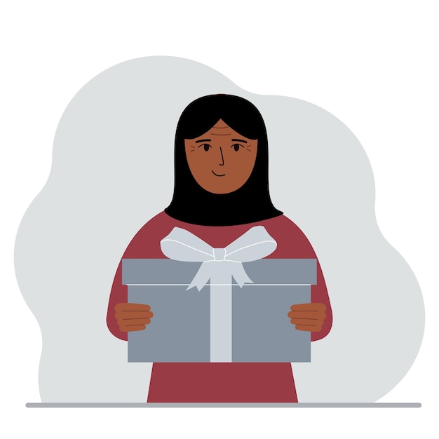 Happy muslim woman holds a large gift box with a bow in his hands Vector