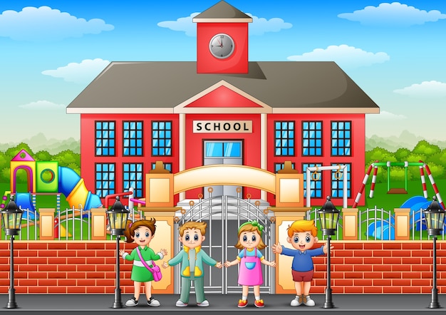 Happy school children standing in front of school building