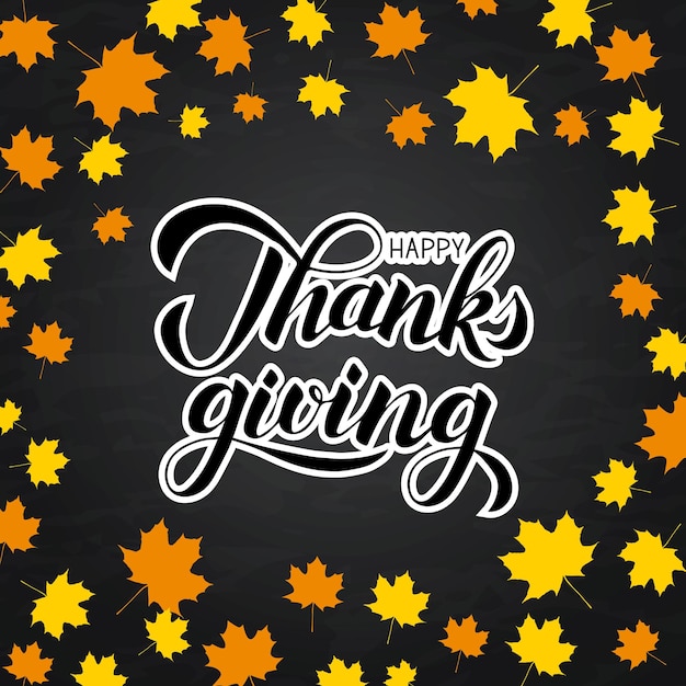 Happy Thanksgiving written with brush on chalkboard background Autumn fall leaves frame and calligraphy lettering