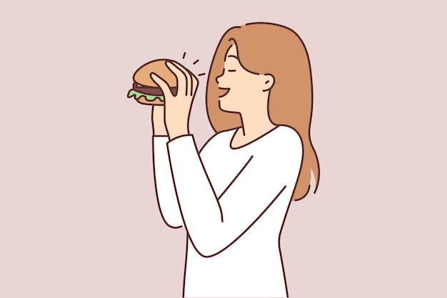 Happy woman eating hamburger