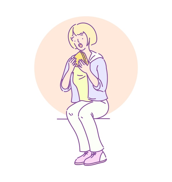 Hungry cute teenage girl sitting and eating sandwich