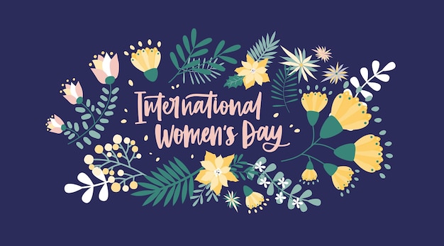 International Women's Day lettering handwritten with calligraphic font and surrounded by spring flowers and inflorescences