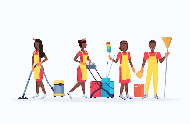 janitors team cleaning service concept african american male female cleaners in uniform working together with professional equipment flat full length horizontal