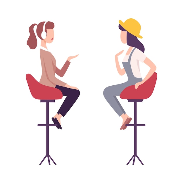 Journalist in headphones interviewing female celebrity two young woman sitting on high chairs and