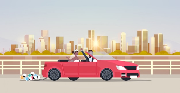 just married bridegroom bride on road trip driving convertible car   couple in love wedding day concept cityscape background horizontal flat