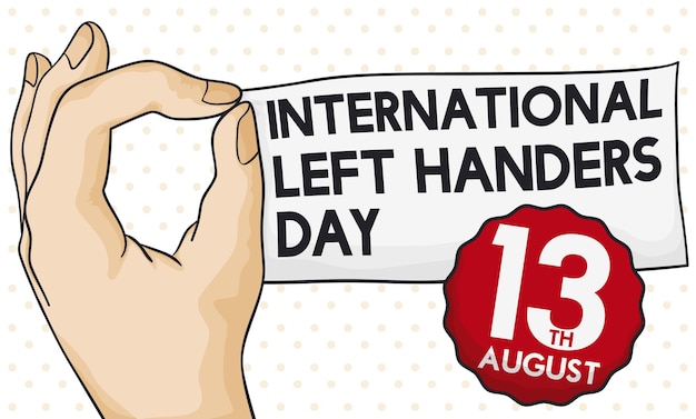 Left hand gripping a greeting paper and a label with reminder for International Left Handers Day