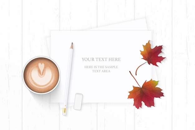 letter paper on autumn maple leaf with pencil and coffee on wooden background