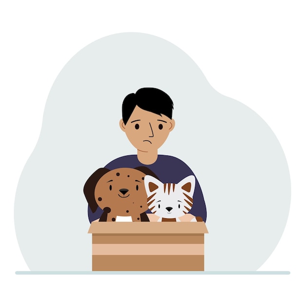 A little boy holds a cardboard box with a cat and a dog The concept of rescue help and care for pets