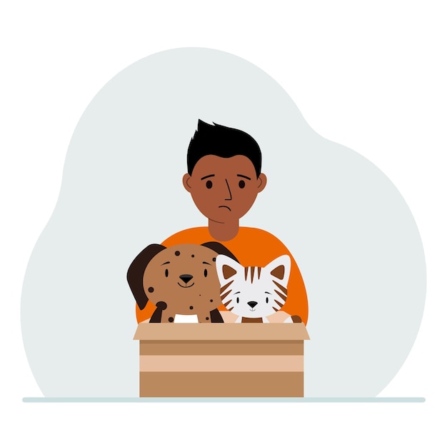 A little boy holds a cardboard box with a cat and a dog The concept of rescue help and care for pets