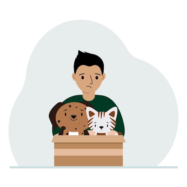 A little boy holds a cardboard box with a cat and a dog The concept of rescue help and care for pets