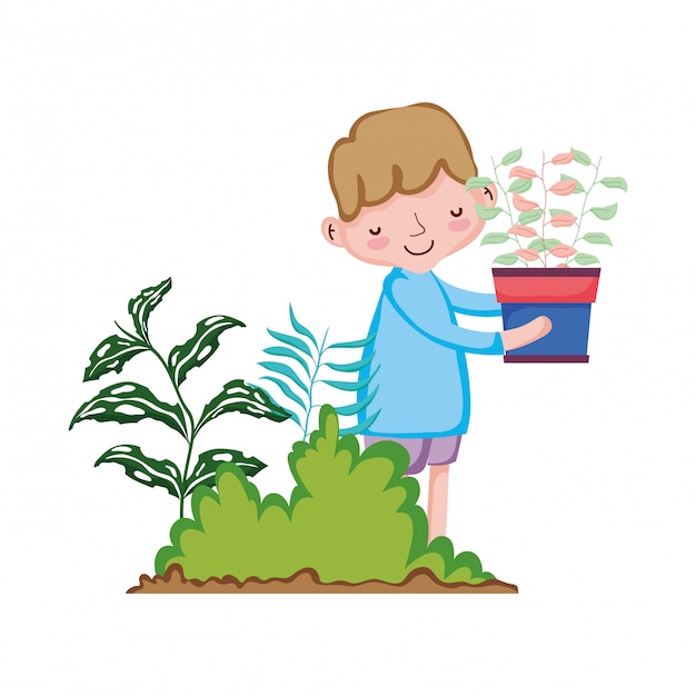 Little boy lifting houseplant in the garden