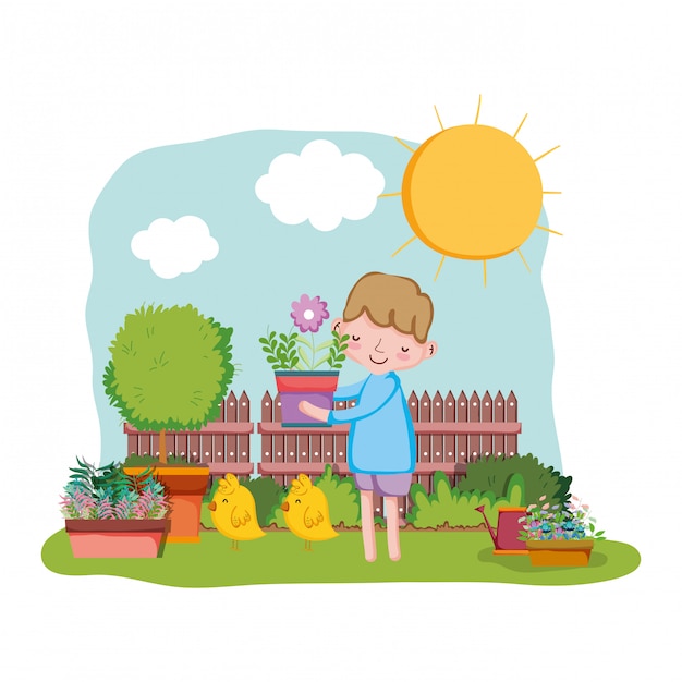 Little boy lifting houseplant with fence and chick