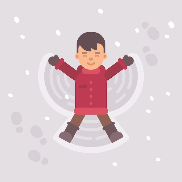 Little boy making a snow angel