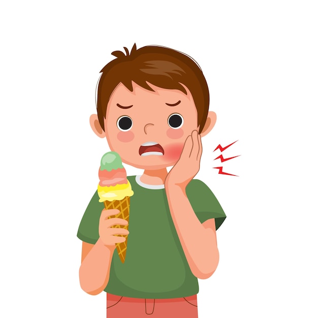 Little boy with sensitive teeth has a toothache while eating cold ice cream