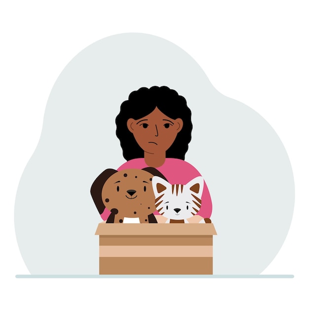 A little girl holds a cardboard box with a cat and a dog The concept of rescue help and care for pets