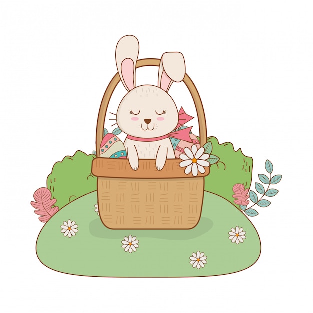 Little rabbit with egg painted in basket on the garden