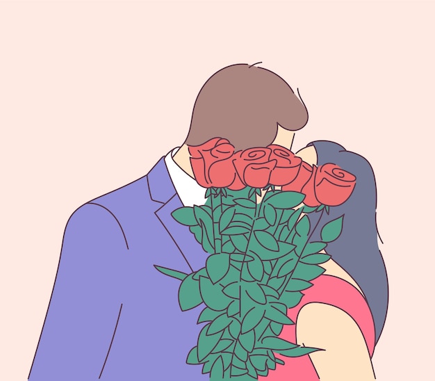 Love, dating, romance, relationship, togetherness, couple concept. The couple kisses and covers their faces with a bouquet.