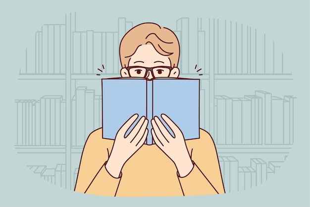 Man in glasses reading book in library