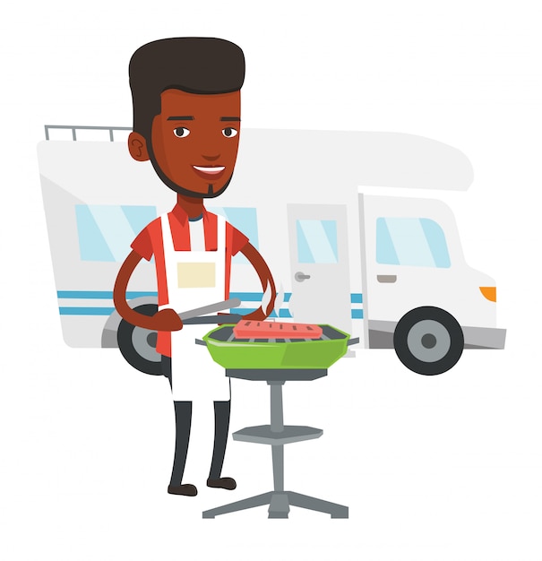 Man having barbecue in front of camper van.