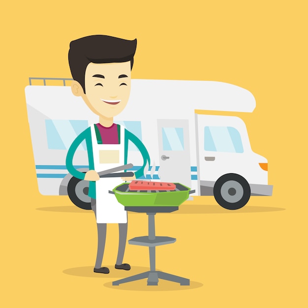 Man having barbecue in front of camper van.