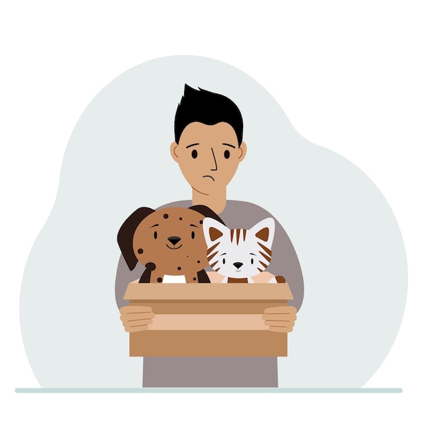 A man holds a cardboard box with a cat and a dog The concept of rescue help and care for pets